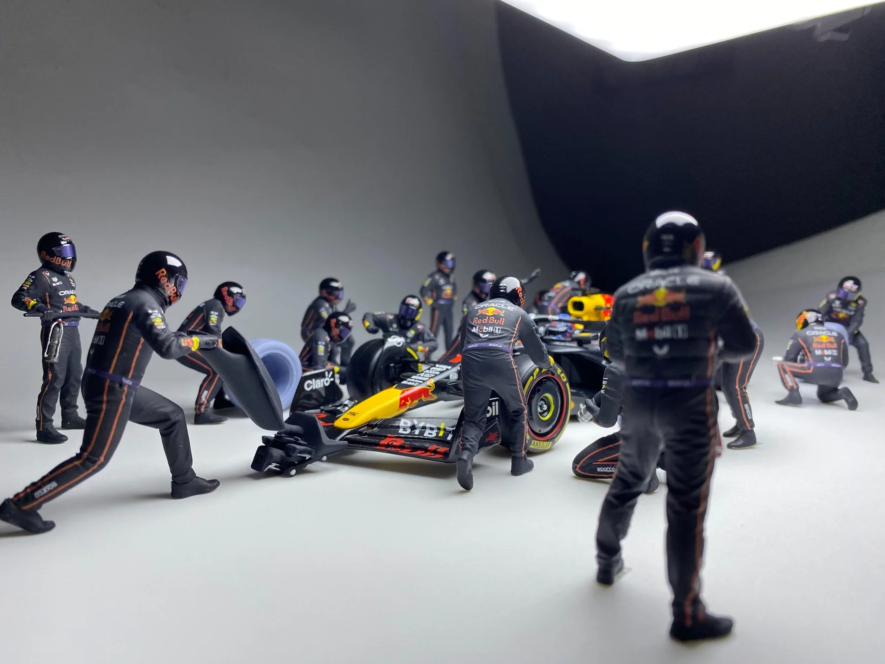 Detailed painted racing pit crew miniatures photographed in a studio